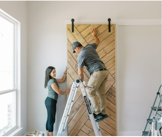 Oscar and Marla Santiago, owners of Wooden Woodworks, on a job site