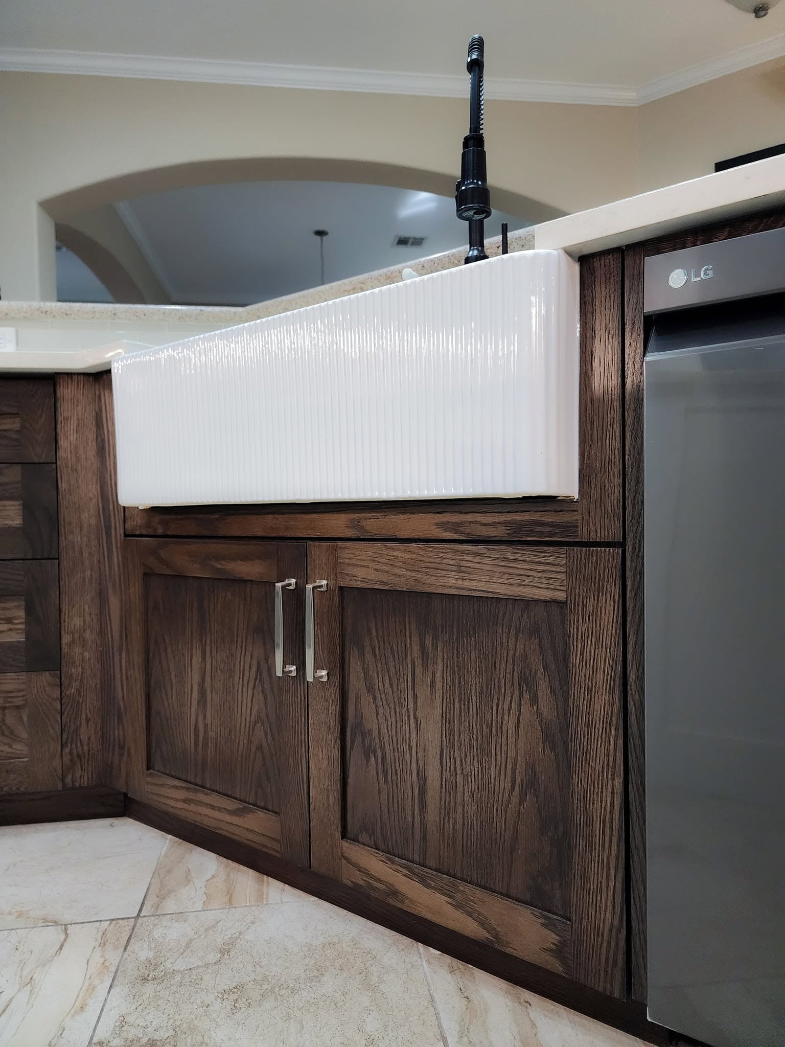Nickel bar pulls below a white ribbed farmhouse sink