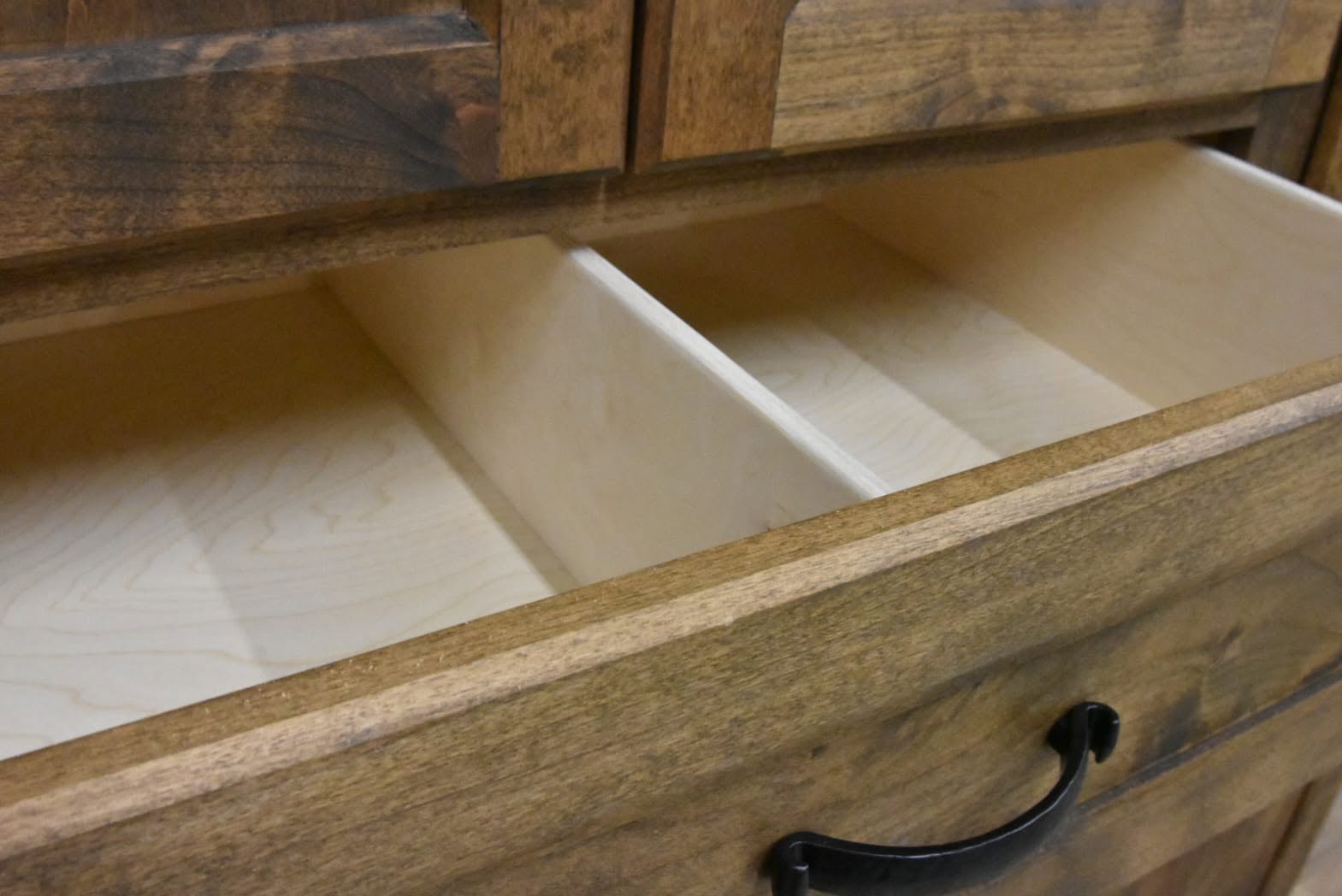 Black bail-style drawer pull on an open dresser drawer