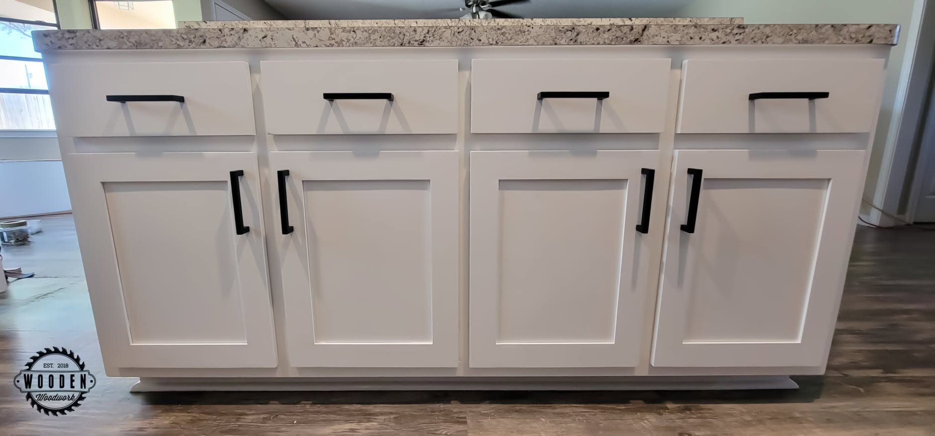 Matte black bar-style pulls across a kitchen island front