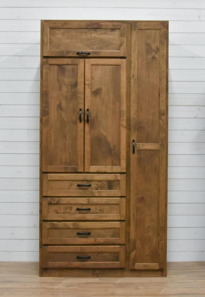 Black bar and loop-style pulls on a wood wardrobe's doors and drawers