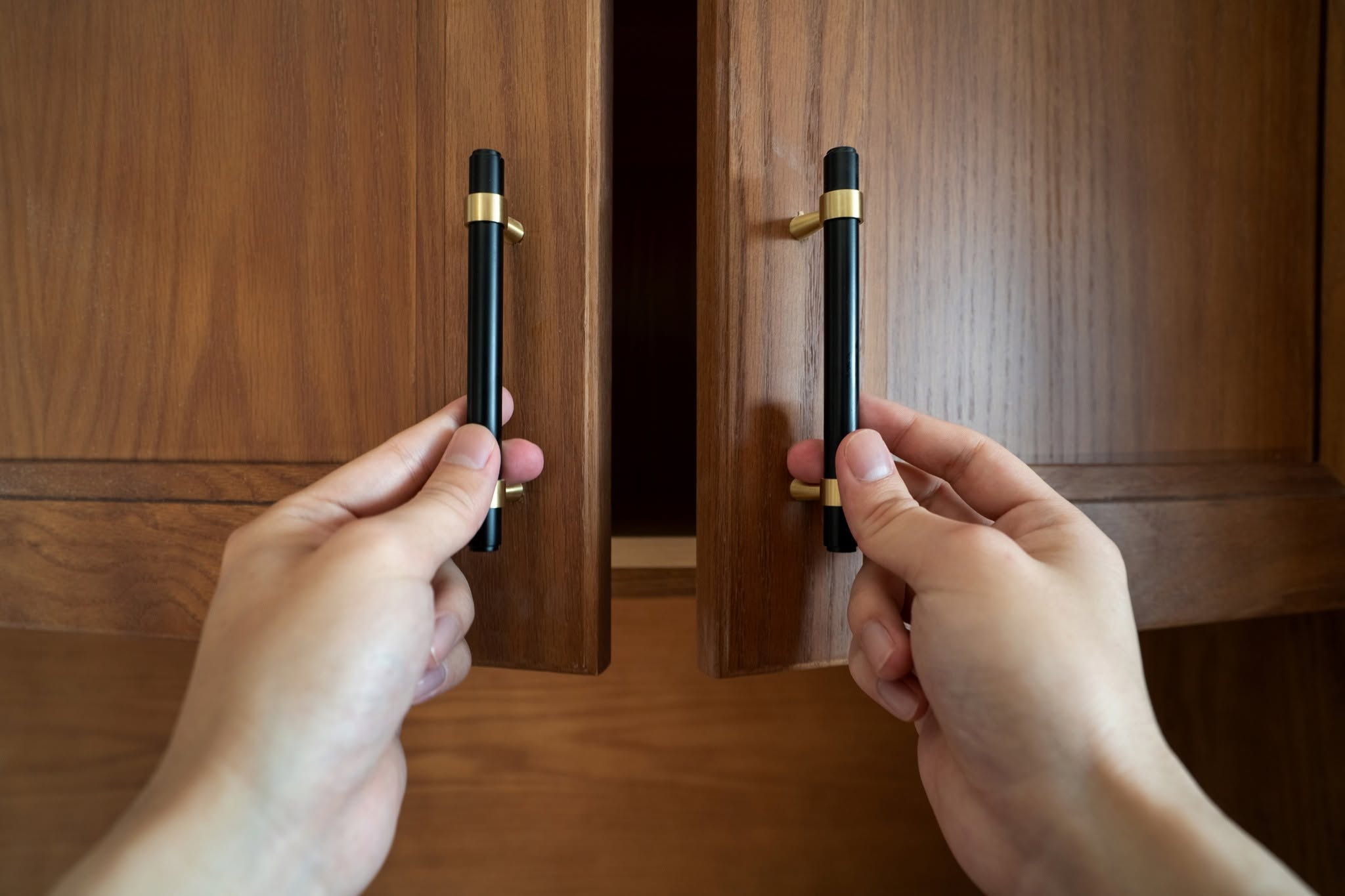 Installing matching black pipe-style pulls with brass ring accents