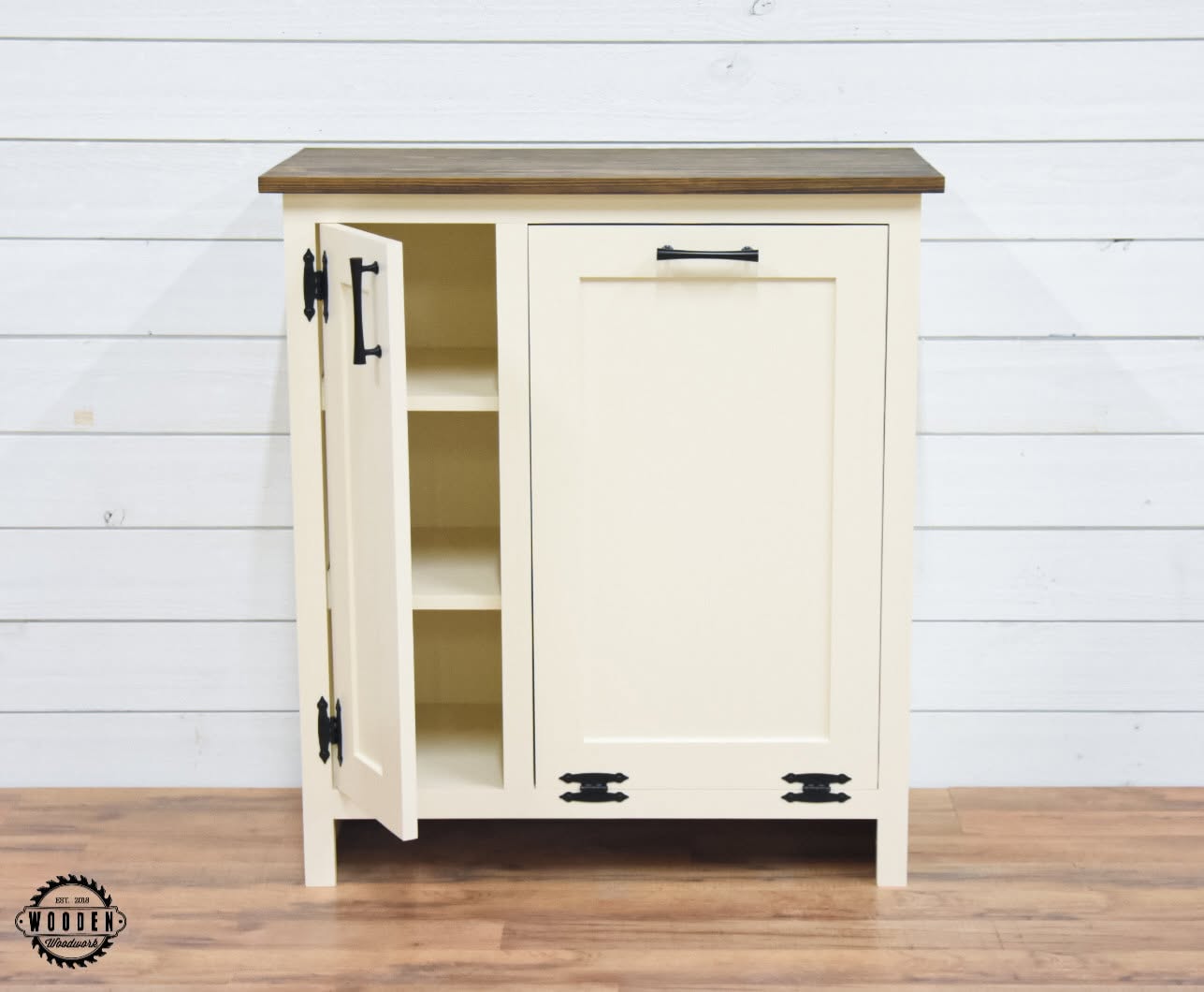 Black strap hinges and bar pull, tilt-out cabinet door open